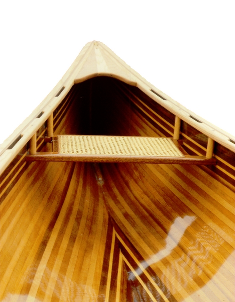 Varnished interior of a timber canoe viewed from the bow.