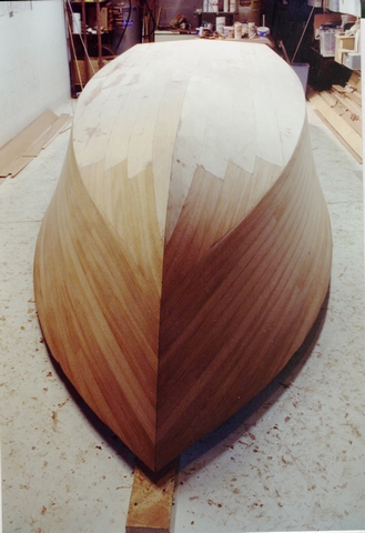 An overturned hull sanded and prepared for its final coating.